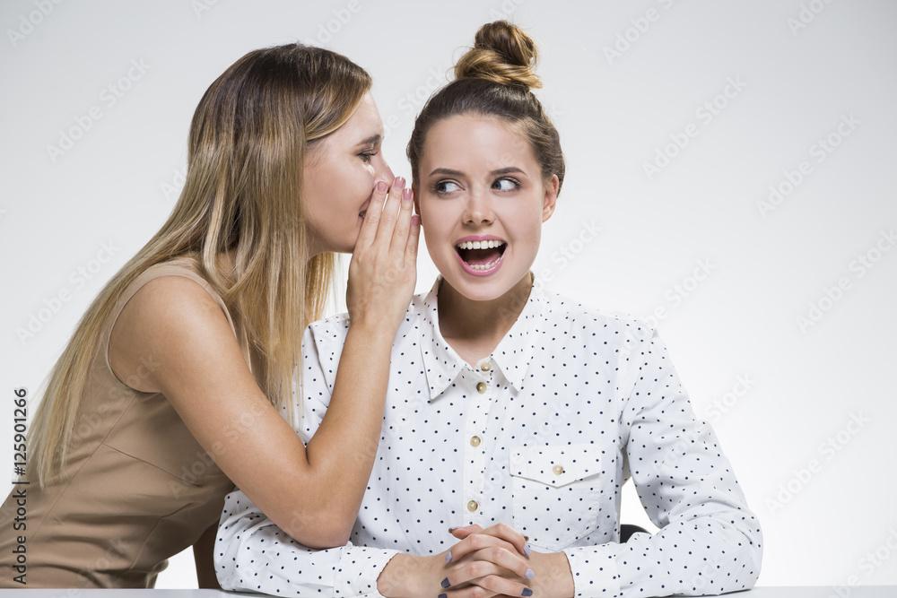 Two girls are gossiping Two girls are gossiping
