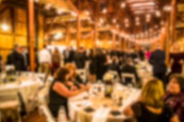 Defocused blur of wedding reception with guests dining and dancing