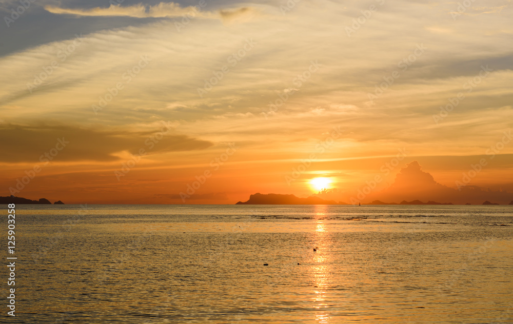 Panoramic golden sunset sky and tropical sea at dusk