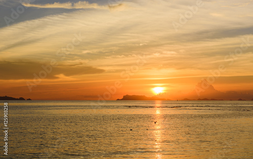Panoramic golden sunset sky and tropical sea at dusk