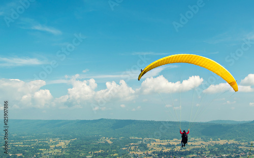 One woman paragliding during autumn evenings, beautiful landscape. Thailand . The challenge courage