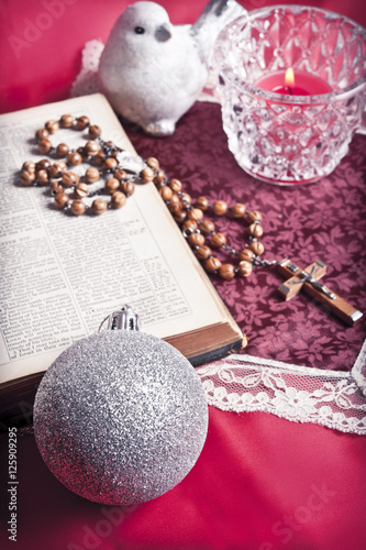 Christmas still-life background with decorations, a bible and a Christian cross
