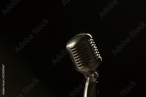 old style 55 microphone on stage black bg looking room