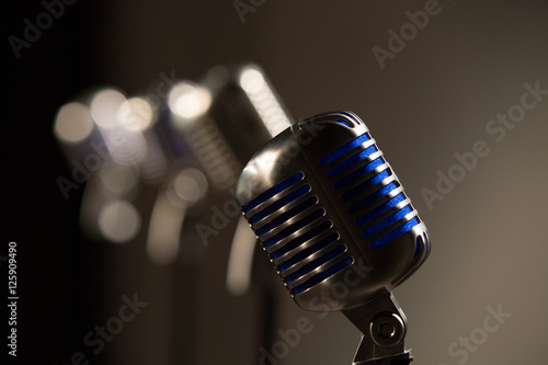 old style 55 microphone on stage in a row fg in focus blue inside