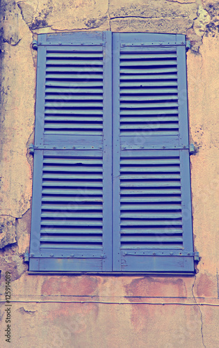 Vintage blue close window with shutters