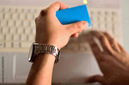 Person making online card payment on laptop computer