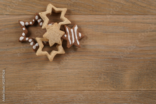 star shaped gingerbread and chocolate cookies on wooden background