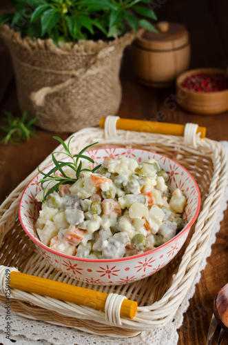 Russian traditional salad Olivier with vegetables and meat © vkuslandia