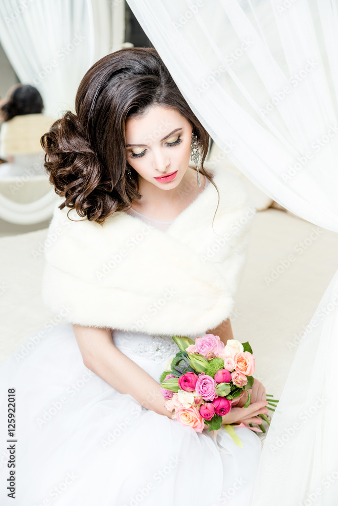 gorgeous bride in luxury wedding dress. Bride. Perfect Make up. Hairstyle, wedding  jewelry. Beautiful Woman with Shiny Brown Hair. gorgeous wedding bouquet of various flowers.