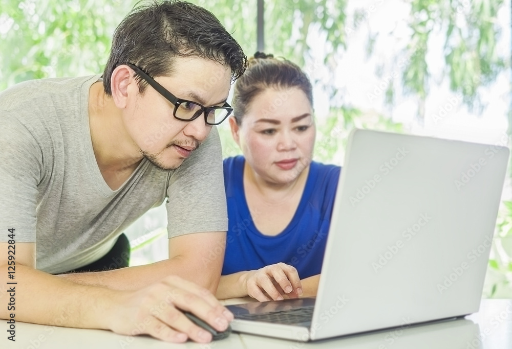 A man is training a woman working with computer in modern office A man is training a woman working with computer in modern office