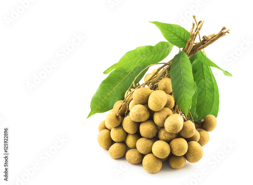 Bunch of longan, dimocarpus, with its leaves isolated over white