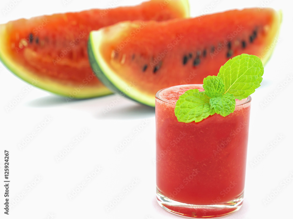 Selective focus of fresh watermelon in a glass with mint decoration on white background Selective focus of fresh watermelon in a glass with mint decoration on white background
