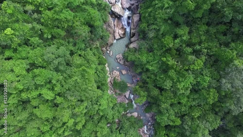 Aerial View of Waterfall in the Mountains Surrounded by Tropical Rainforest Aerial View of Waterfall in the Mountains Surrounded by Tropical Rainforest