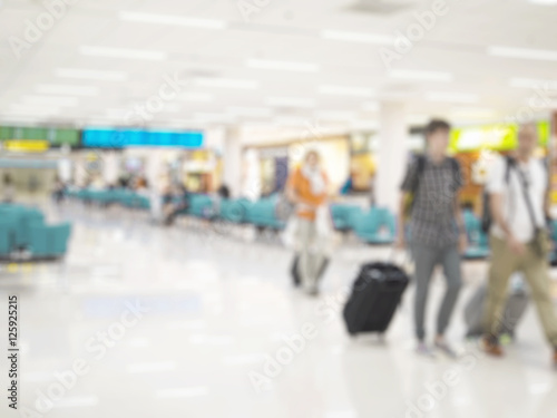 Blurred photo of travelers are walk in airport terminal