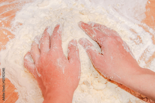 Girl's hand with the dough.