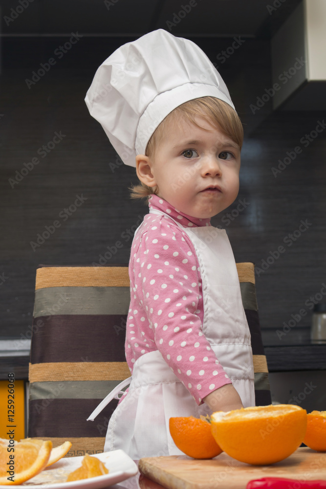 clouse-up portrait smile little cute girl in chef suit. Mother's helper. 2 year old. clouse-up portrait smile little cute girl in chef suit. Mother's helper. 2 year old.