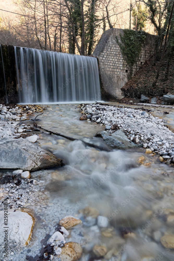 Fototapeta premium Waterfall and stream at Loutra Pozar of Aridaia in Macedonia, Greece