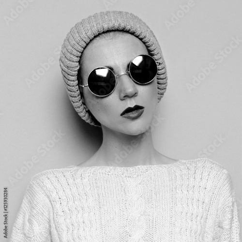 Hipster Girl in style knitted hat and sunglasses photo