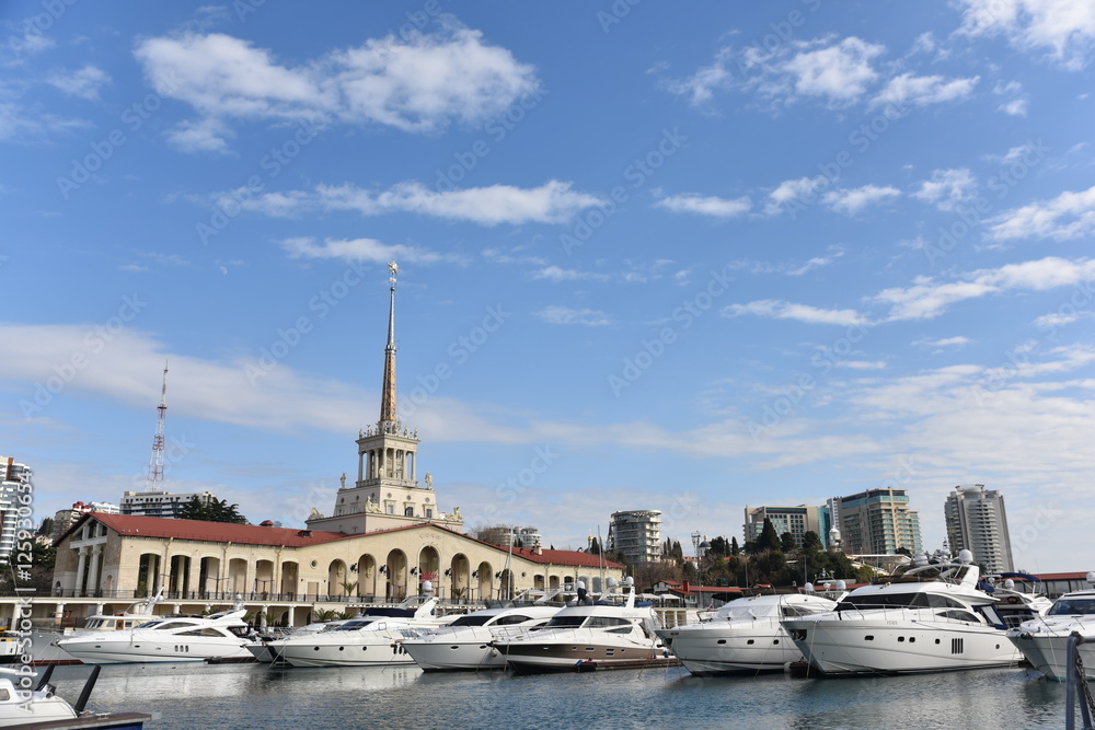Yachts moored on the waterfront of the city  a Sunny summer day. District  Sochi, Russia