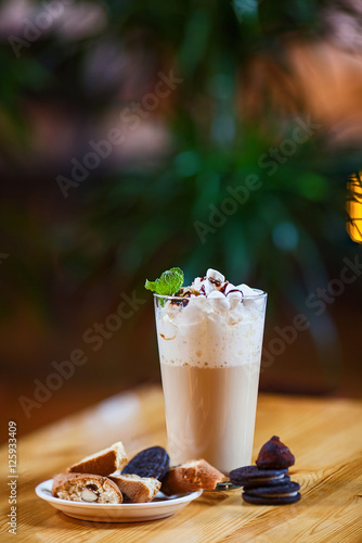 coffee drink on a table with cookies on a dark background