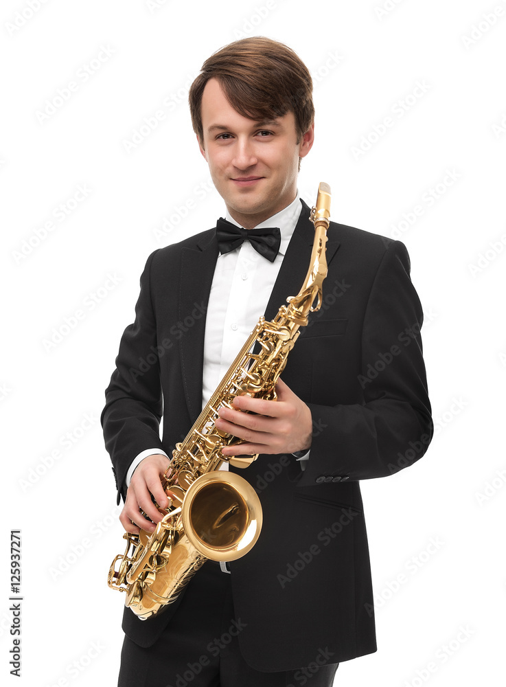 Fototapeta premium Attractive saxophonist with a saxophone in a suit.