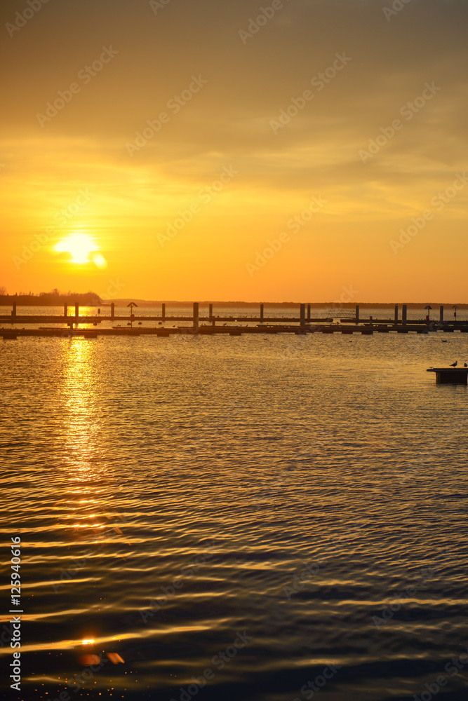 Yacht port over orange sunset