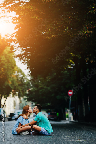 couple sitting on pavement square