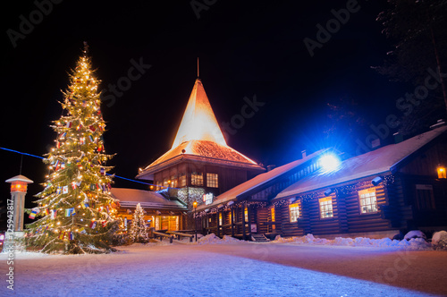 Santa Claus' Village in Finland surrounded by Christmas trees photo