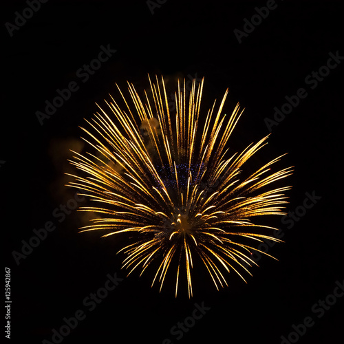 Golden fireworks on black background