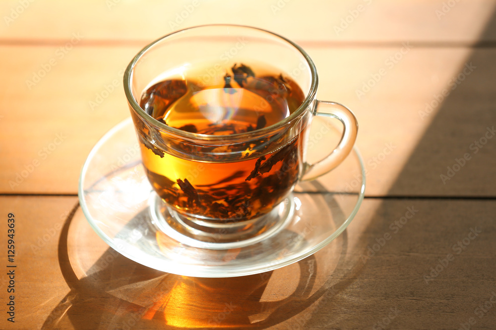 Glass cup of tea on wooden table Glass cup of tea on wooden table
