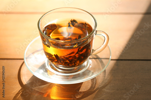 Glass cup of tea on wooden table