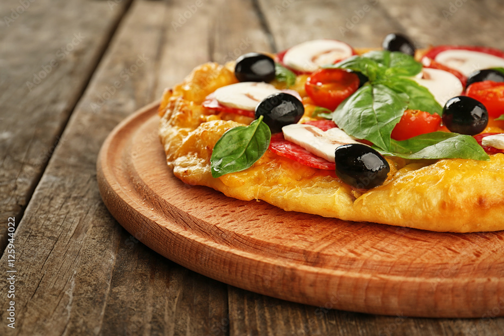 Delicious pizza with mushrooms, cherry tomatoes, olives and basil on wooden background Delicious pizza with mushrooms, cherry tomatoes, olives and basil on wooden background