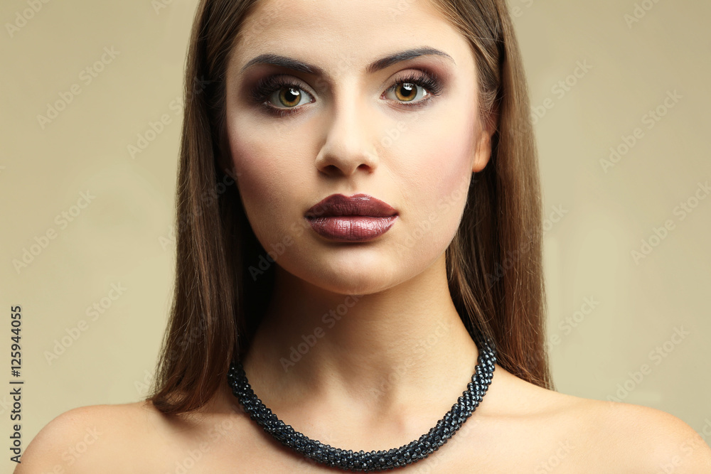 Portrait of beautiful young woman with professional makeup on colour background Portrait of beautiful young woman with professional makeup on colour background
