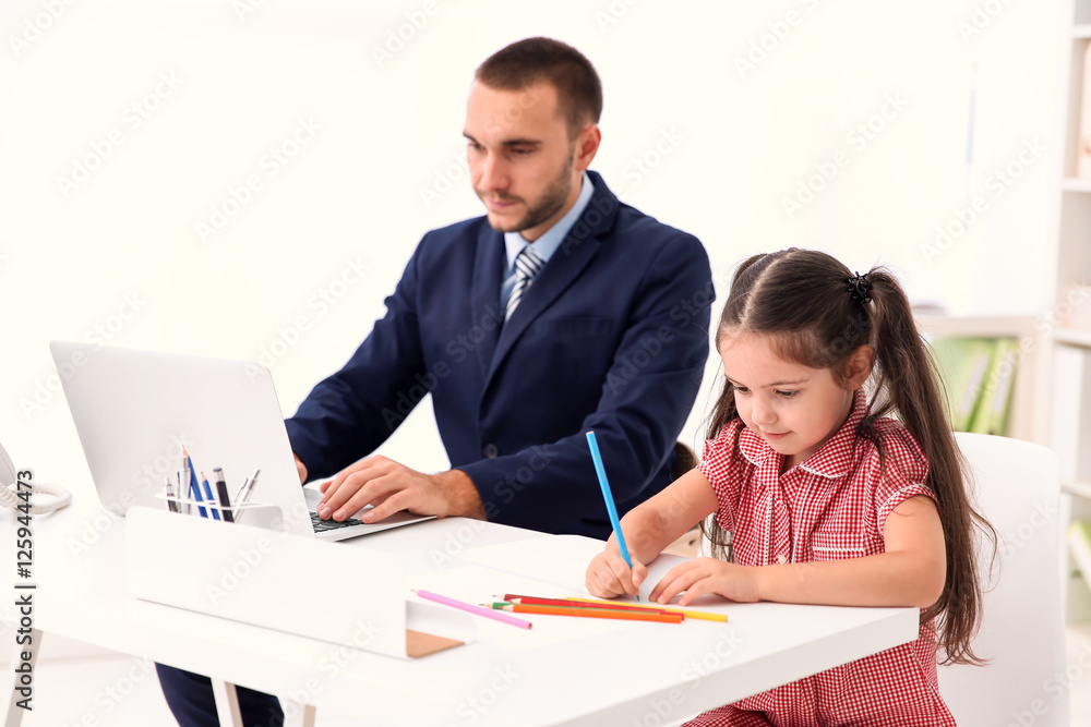 Daughter helping father working in office Daughter helping father working in office