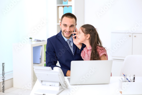 Daughter helping father wor...