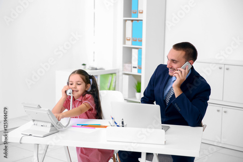 Daughter helping father wor...