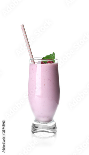 Glass of raspberry milk shake on white background