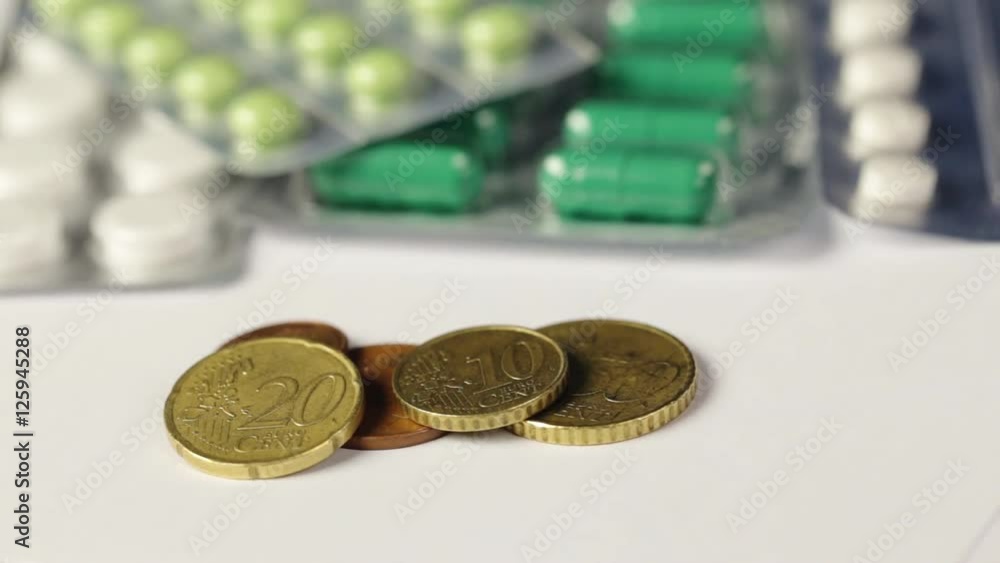 Medicine pills or capsules with money and syringe on white background