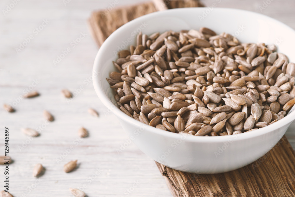 White ceramic bowl with sunflower seeds White ceramic bowl with sunflower seeds