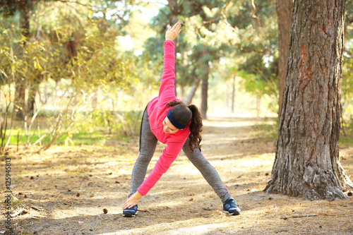 Young woman stretching outd...