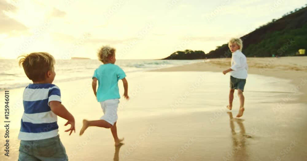 Happy family playing and having fun on the beach at sunset Happy family playing and having fun on the beach at sunset