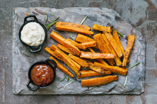 Bild auf Leinwand Sweet Potato Fries Top View on Slate with Ketchup and Mayonnaise