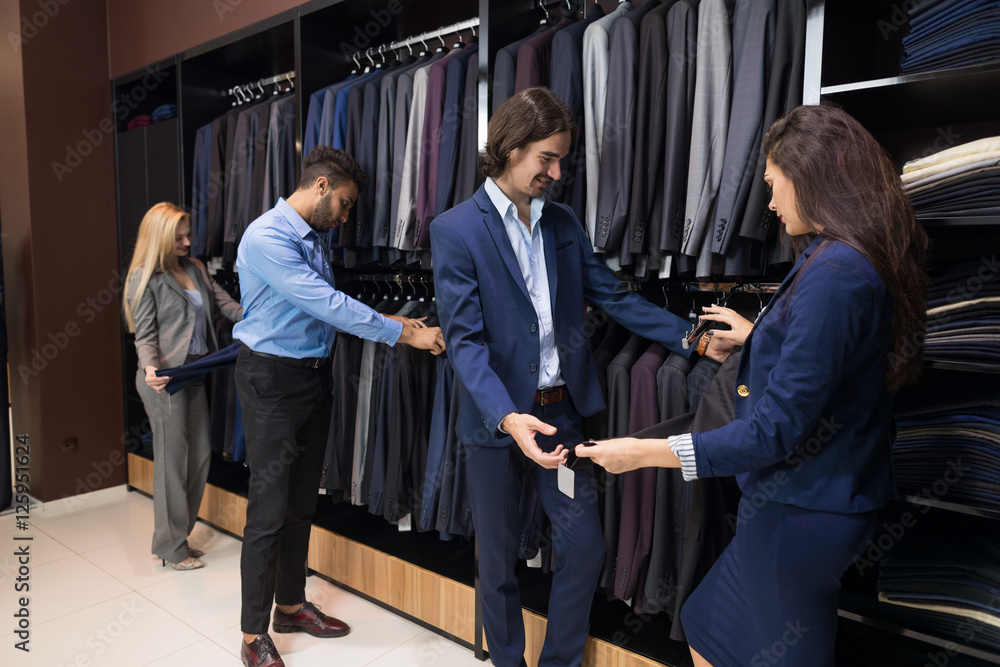 Handsome Business Man And Woman Fashion Shop, Customers Choosing Clothes In Retail Store Young People Shopping Formal Wear Handsome Business Man And Woman Fashion Shop, Customers Choosing Clothes In Retail Store Young People Shopping Formal Wear