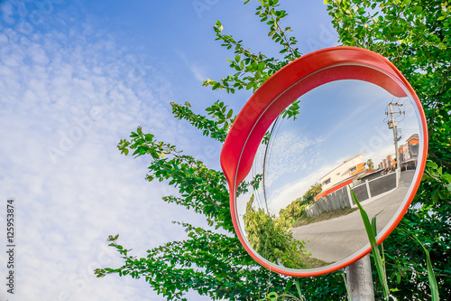 Reflection of road in the traffic safety mirror. photo