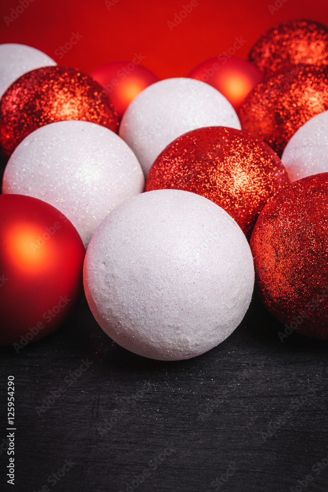 red and white baubles on a black wooden table red and white baubles on a black wooden table