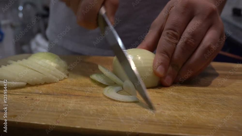 Man cutting onion in the kitchen Man cutting onion in the kitchen