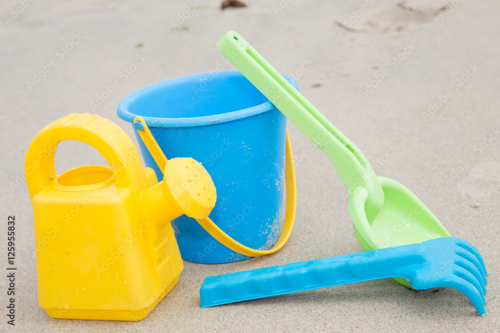 Beach toys in the sand at the beach Beach toys in the sand at the beach