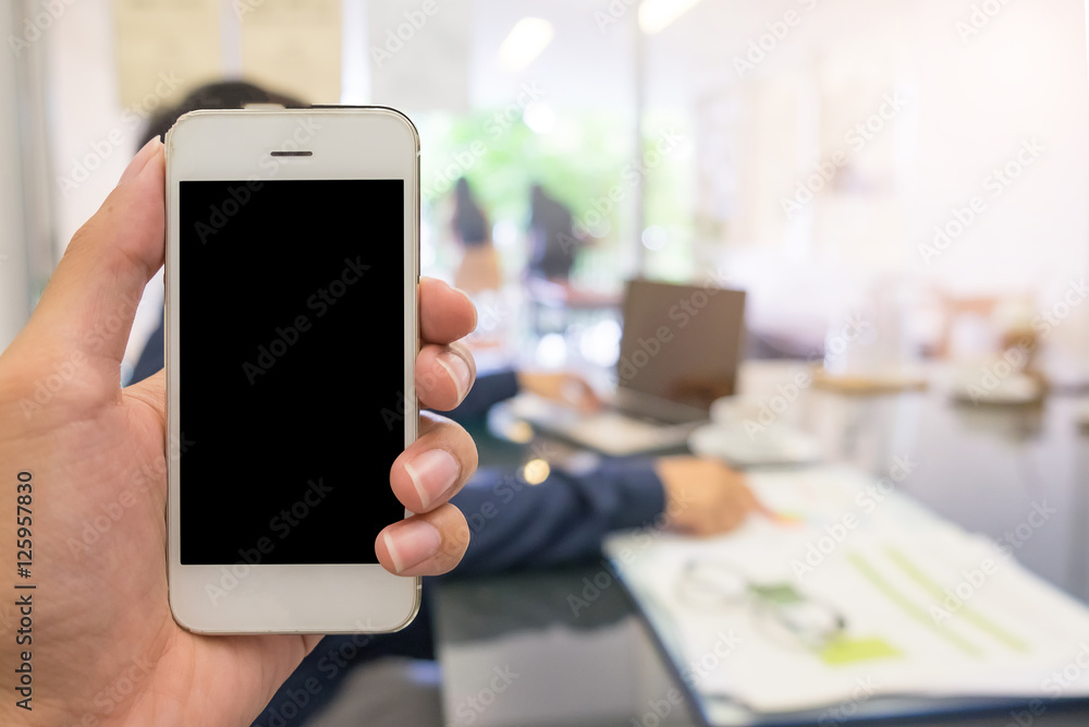 business man hand holding mobile smart phont with blank screen.