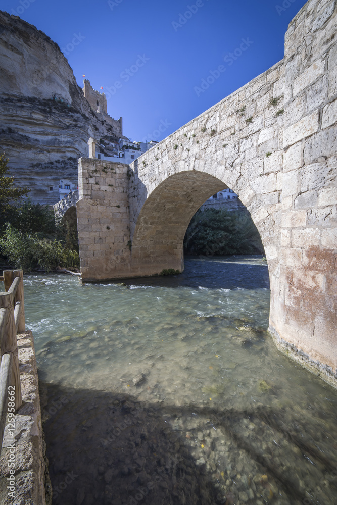Roman bridge, located in the central part of the town, Alcala del Jucar, Spain