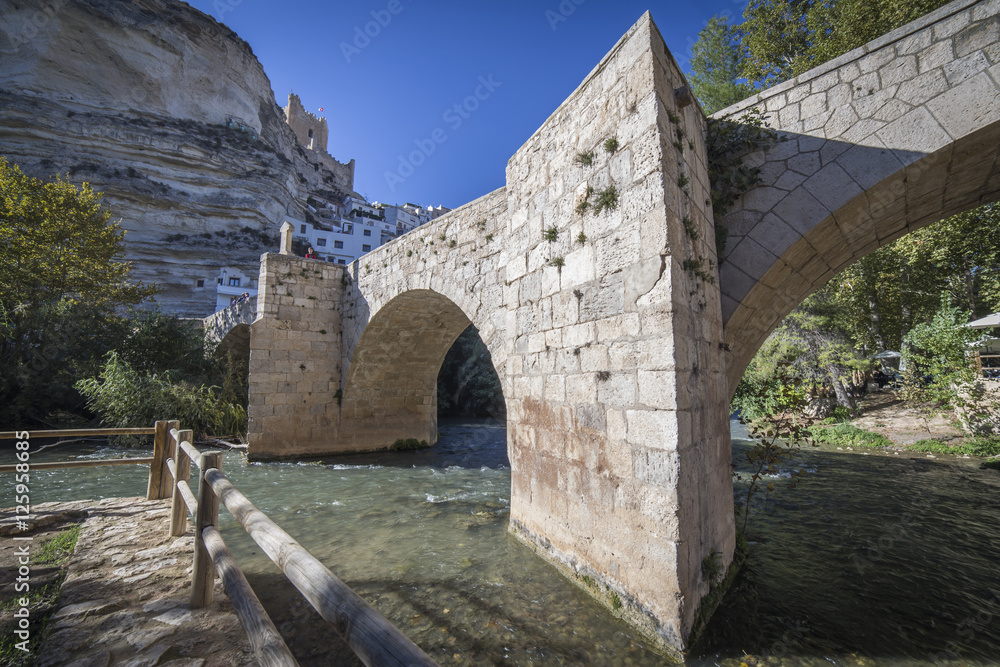 Roman bridge, located in the central part of the town, Alcala del Jucar, Spain